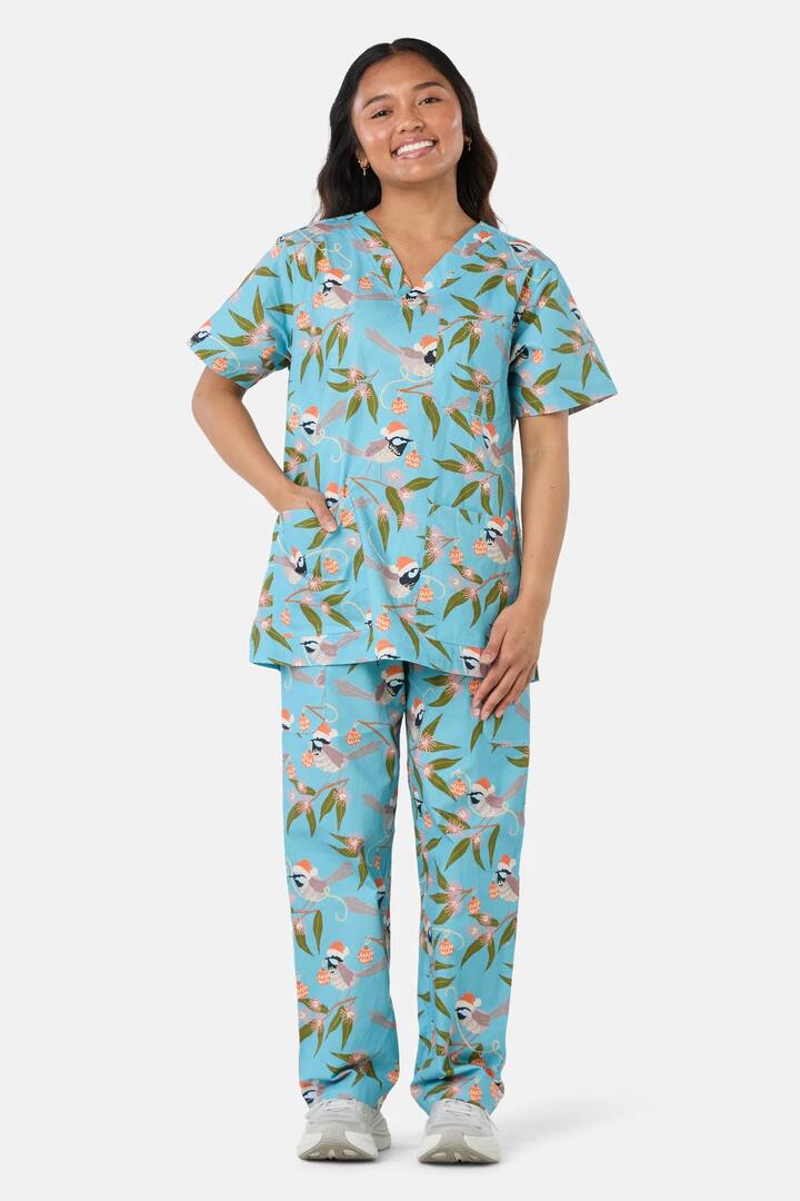 Image of a model wearing Uniforms & Workwear. Product name - Christmas Fairy Wren Scrub Set in Teal colour by brand - Scrubs With Love