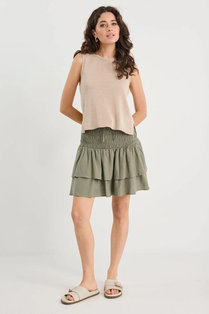 Image of a model wearing Skirts. Product name - Lennox Khaki Shirred Linen Blend Tiered Mini Skirt in Khaki colour by brand - Ivy + Jack