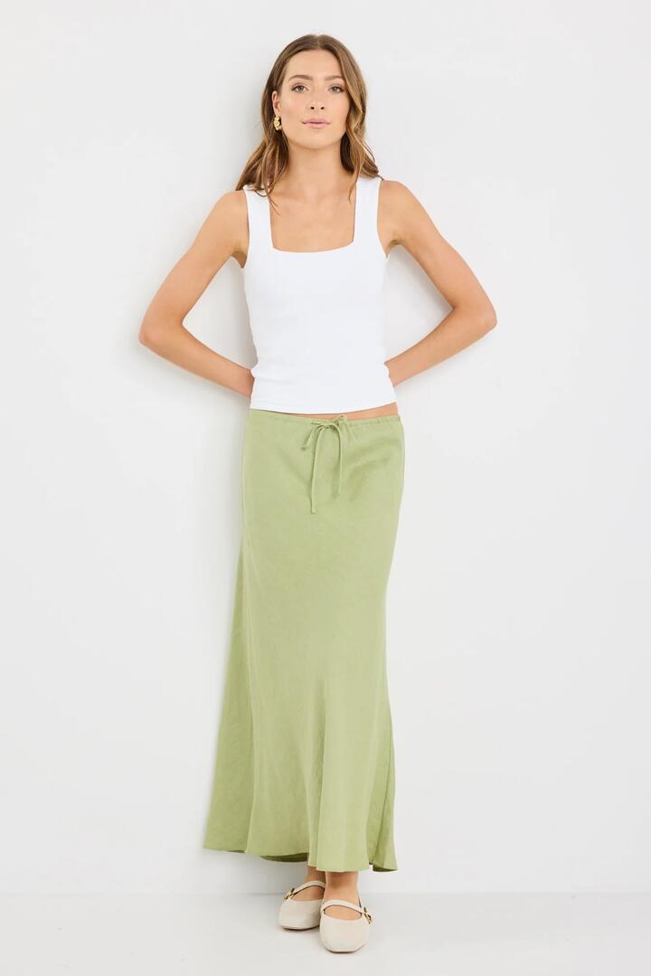 Image of a model wearing Skirts. Product name - Summit Moss Linen Tie Waist Bias Maxi Skirt in Moss colour by brand - Among the Brave