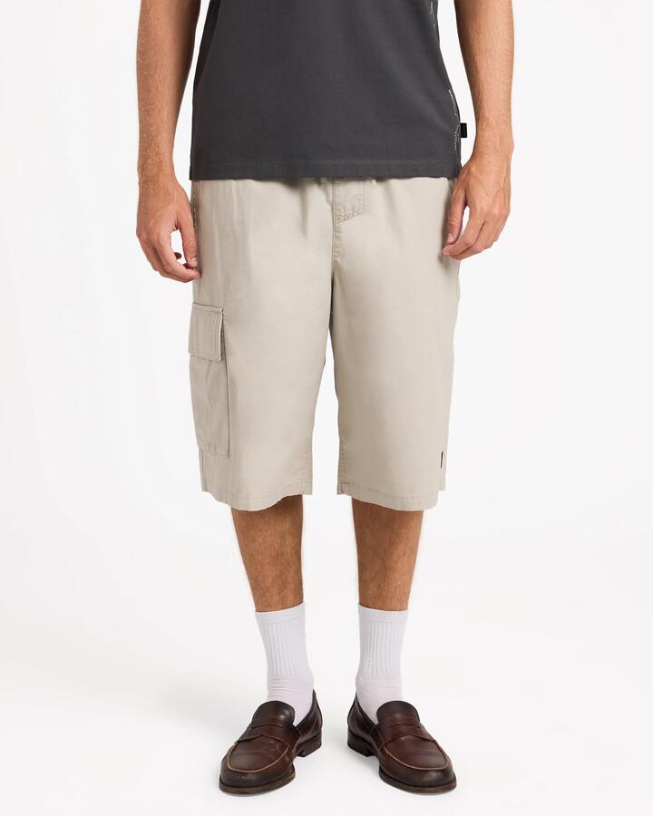 Image of a model wearing Shorts. Product name - RVCA Mens Dayshift Summit 23.5" Hybrid Shorts Taupe in Taupe colour by brand - RVCA