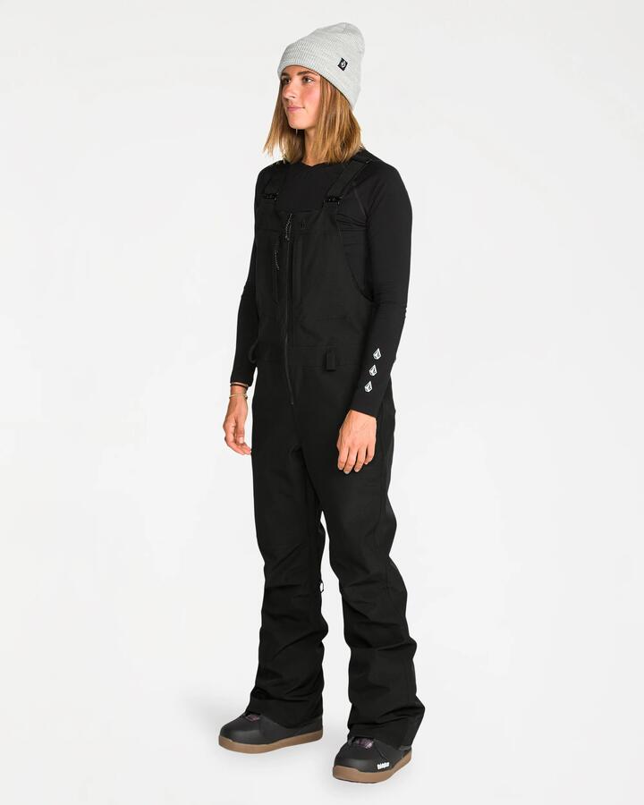 Image of a model wearing Pants. Product name - Volcom Womens Swift Bib Over Pants Black in Black colour by brand - Volcom