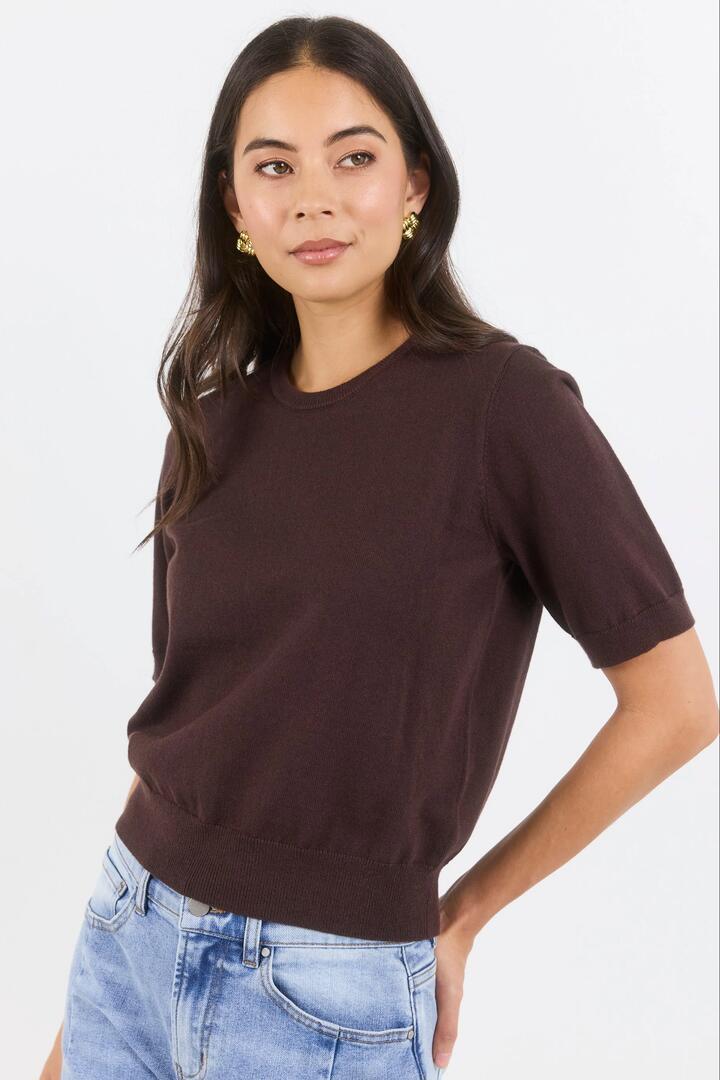 Image of a model wearing Outerwear. Product name - Edition Chocolate Crewneck Cashmere Blend Knit Tee in Chocolate colour by brand - Stories be Told