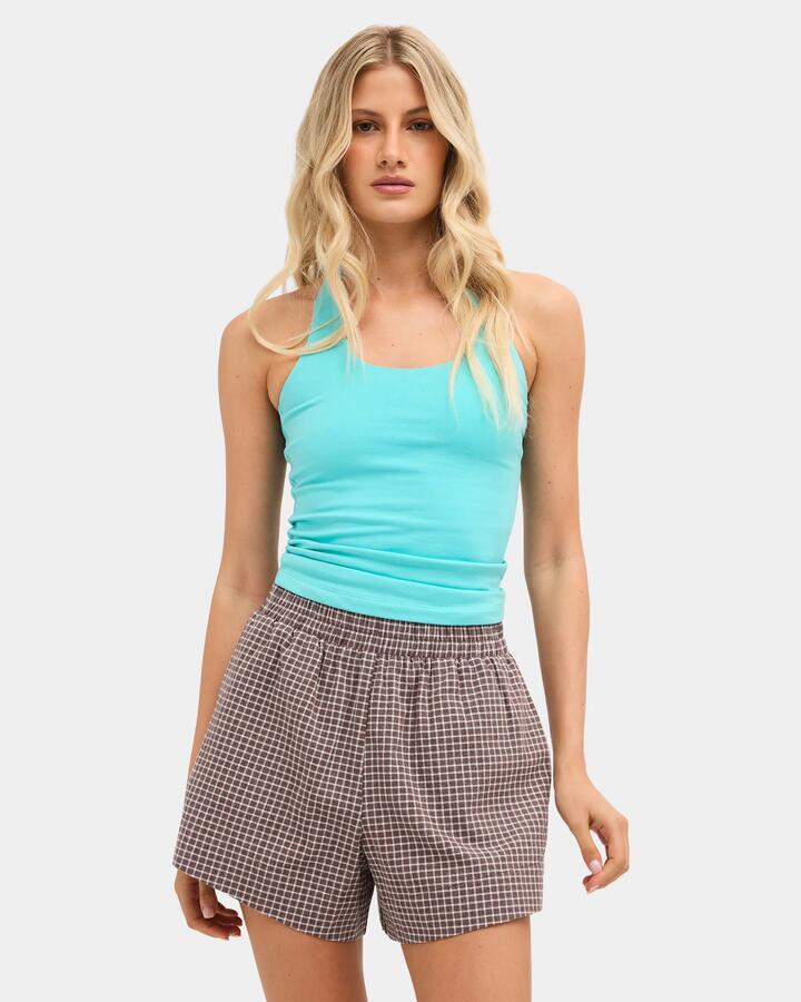 Image of a model wearing Tops. Product name - Nunui Womens Harmony Halter Top Aqua in Aqua colour by brand - Nunui