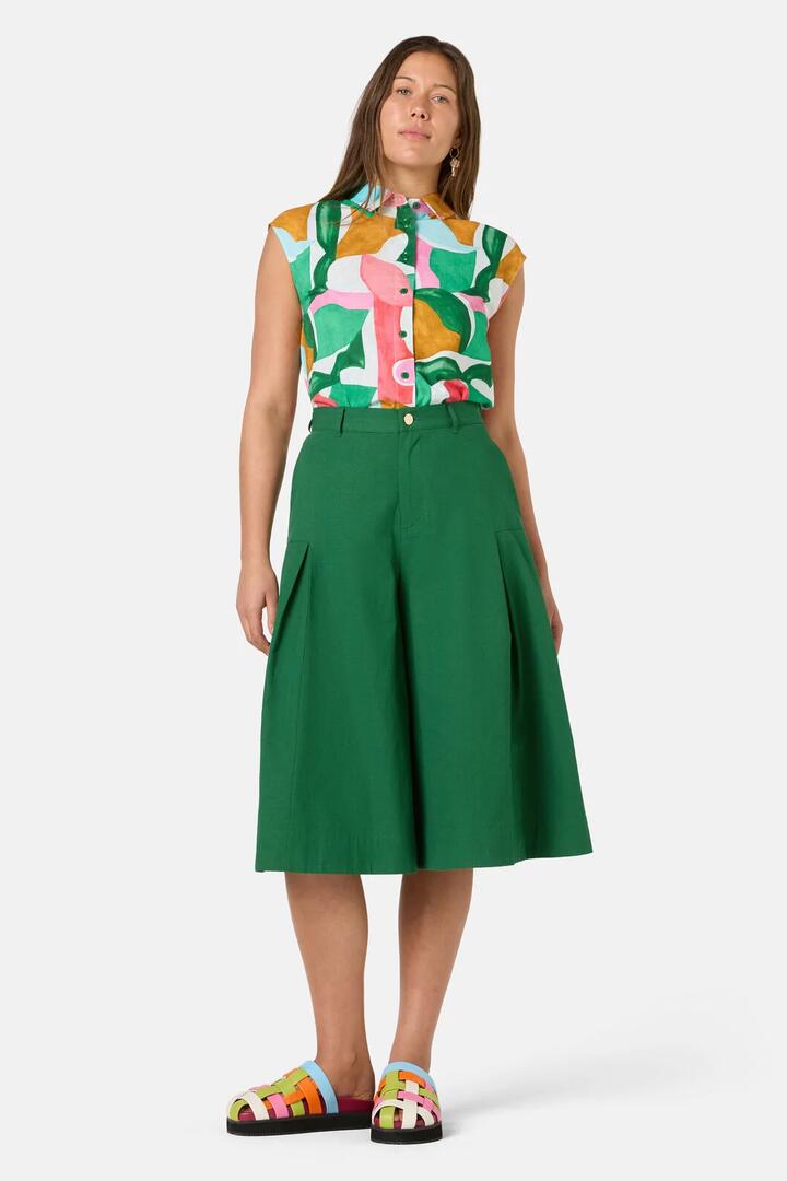 Image of a model wearing Skirts. Product name - Foliage Cotton Pleat Skort in Green colour by brand - Gorman