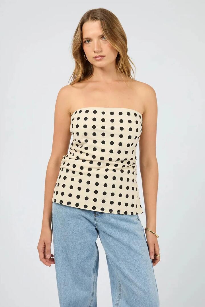 Image of a model wearing Tops. Product name - Nieve Natural Black Spot Strapless Top in Natural colour by brand - Silent Theory