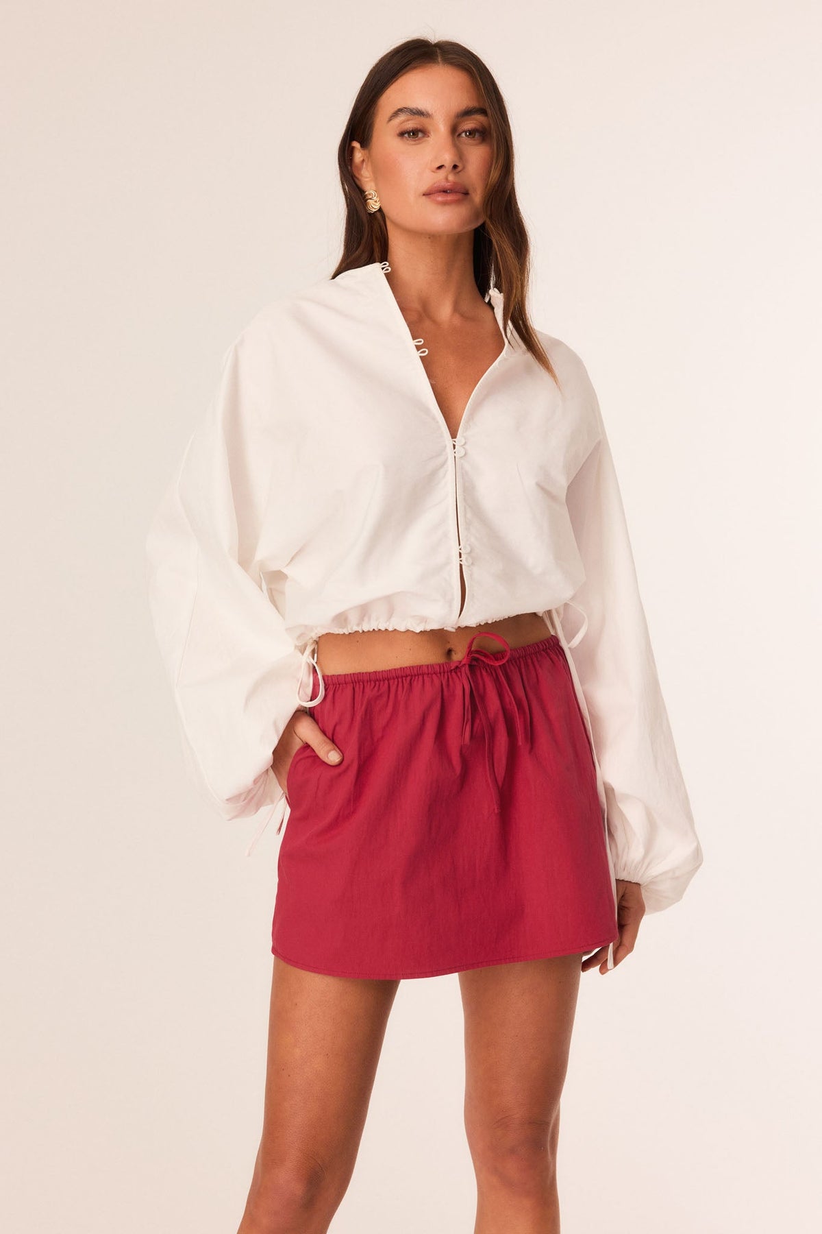 Image of a model wearing Skirts. Productname: SNDYS EMMY MINI SKIRT in Red colour by brand - SNDYS