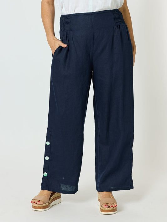 Image of a model wearing Pants. Product name - Bayview Wide Leg Linen Pant Navy in Navy colour by brand - Hammock & Vine