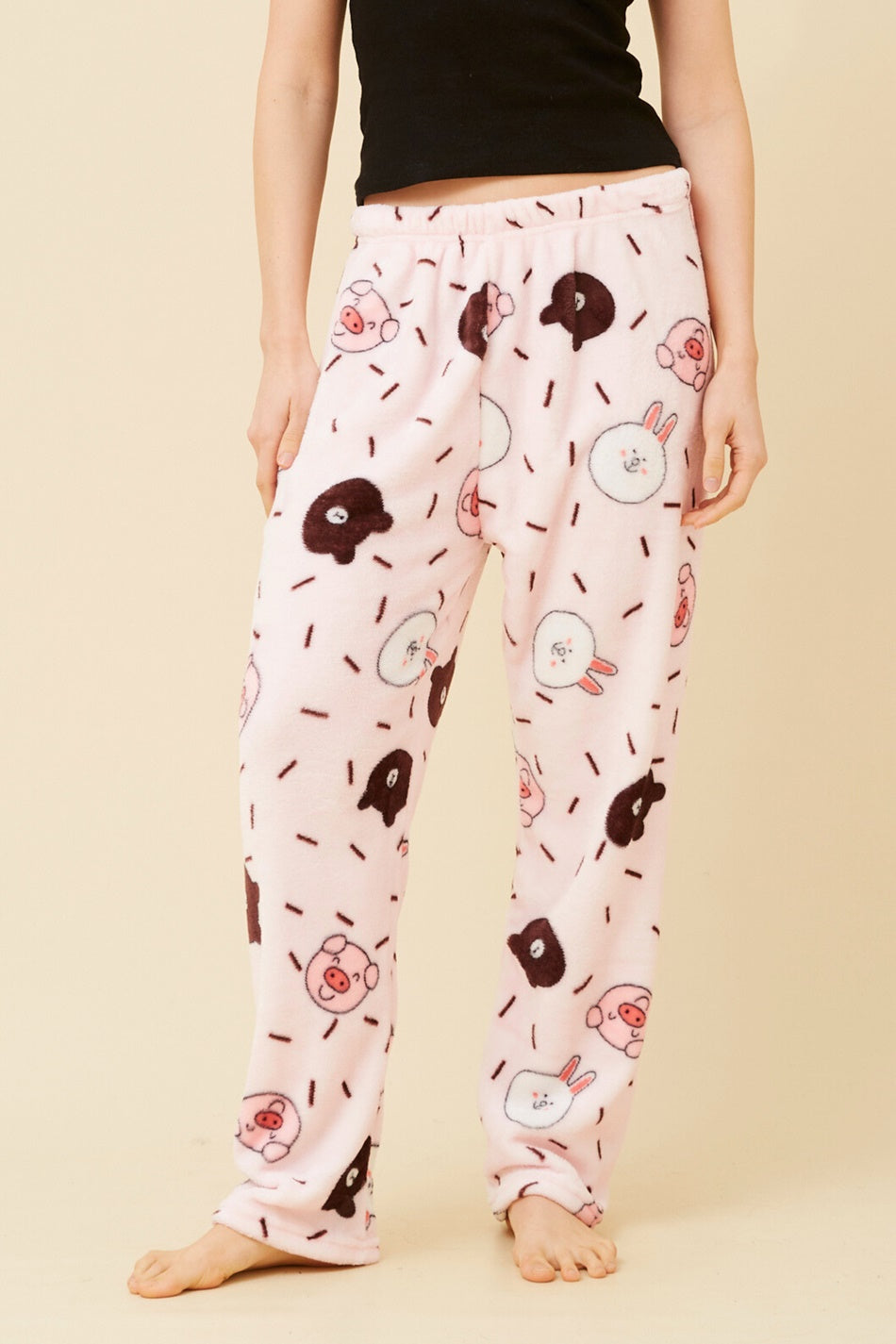 Image of a model wearing Pants. Product name - LEE ANIMAL PRINT PLUSH PYJAMA PANTS in Pink colour by brand - Caroline Morgan Australia