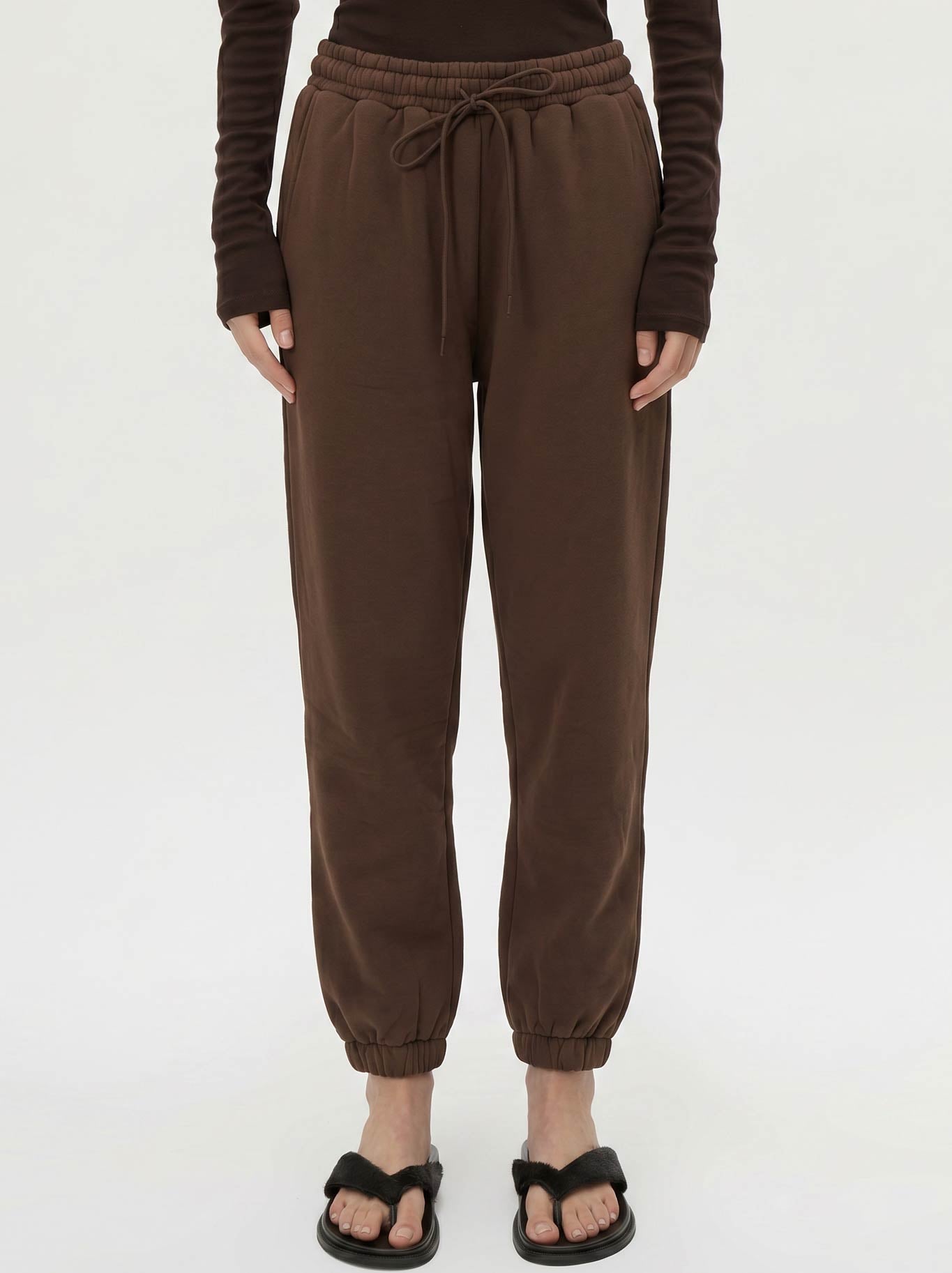 Image of a model wearing Pants. Product name - CAMILLA AND MARC MAREN TRACKPANT in Chocolate colour by brand - Camilla And Marc