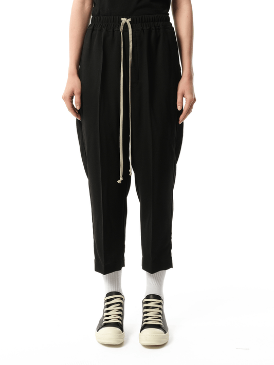 Image of a model wearing Pants. Productname: RICK OWENS Wool Cropped Drawstring Astaires Pants in BLACK colour by brand - RICK OWENS