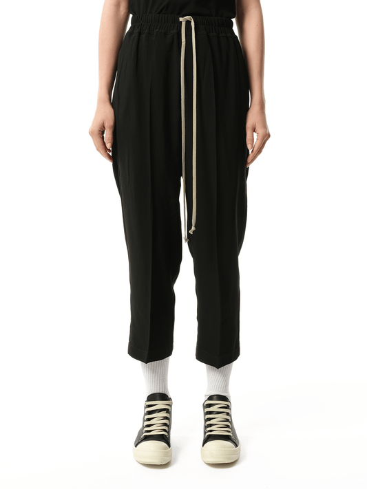 Image of a model wearing Pants. Productname: RICK OWENS Heavy Cady Cropped Drawstring Astaires Pants in Black colour by brand - RICK OWENS