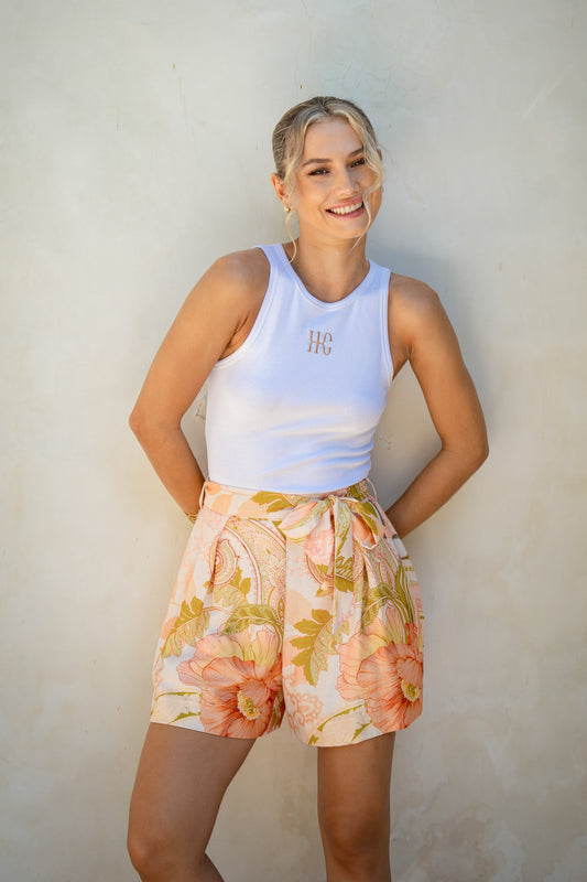 Image of a model wearing Shorts. Product name - Wanderers Pink Floral Shorts in Floral colour by brand - HEYCHIC
