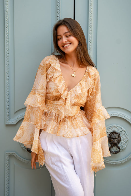 Image of a model wearing Tops. Product name - Sunwoven Paisley Ruffle Blouse in Blouse colour by brand - HEYCHIC