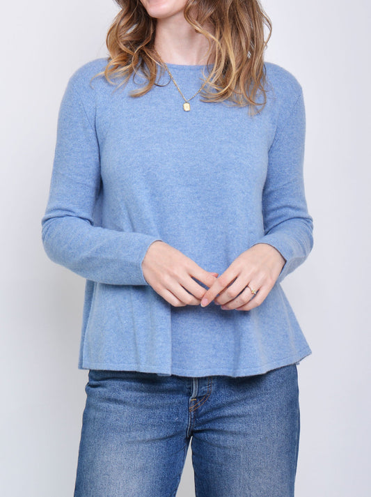 Image of a model wearing Outerwear. Productname: James Melbourne Cashmere Swing Sweater in Biarritz colour by brand - James Melbourne