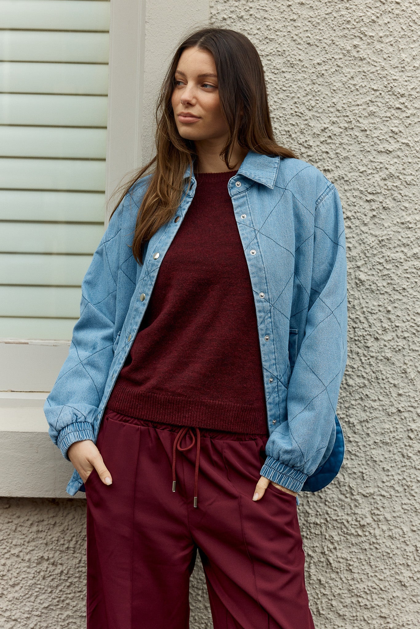 Image of a model wearing Outerwear. Product name - Quest Quilted Jacket Blue Wash in Blue Wash colour by brand - Betty Basics