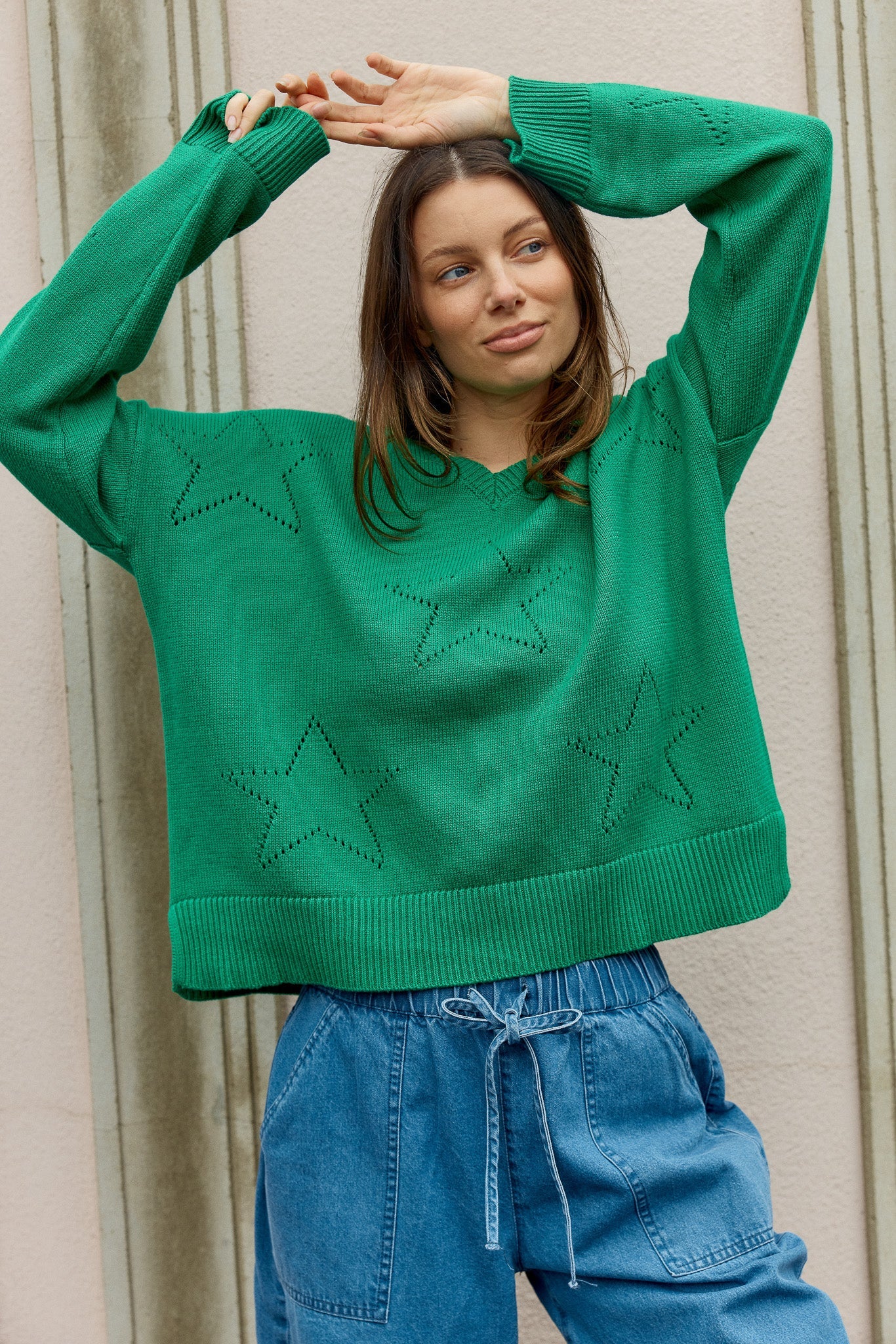 Image of a model wearing Outerwear. Product name - Selene Star Sweater Green in Green colour by brand - Betty Basics