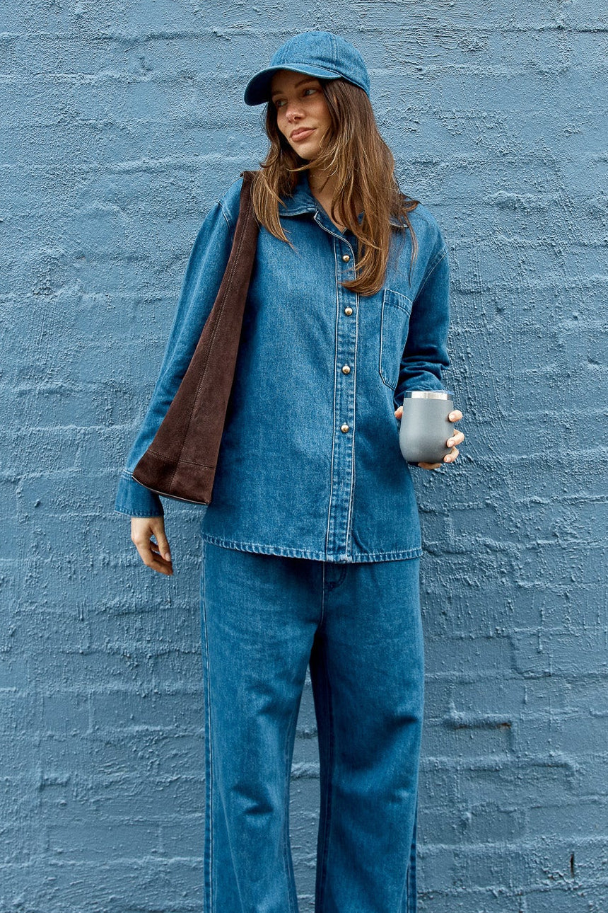 Image of a model wearing Tops. Product name - Vespa Denim Shirt Mid Blue in Mid Blue colour by brand - Betty Basics