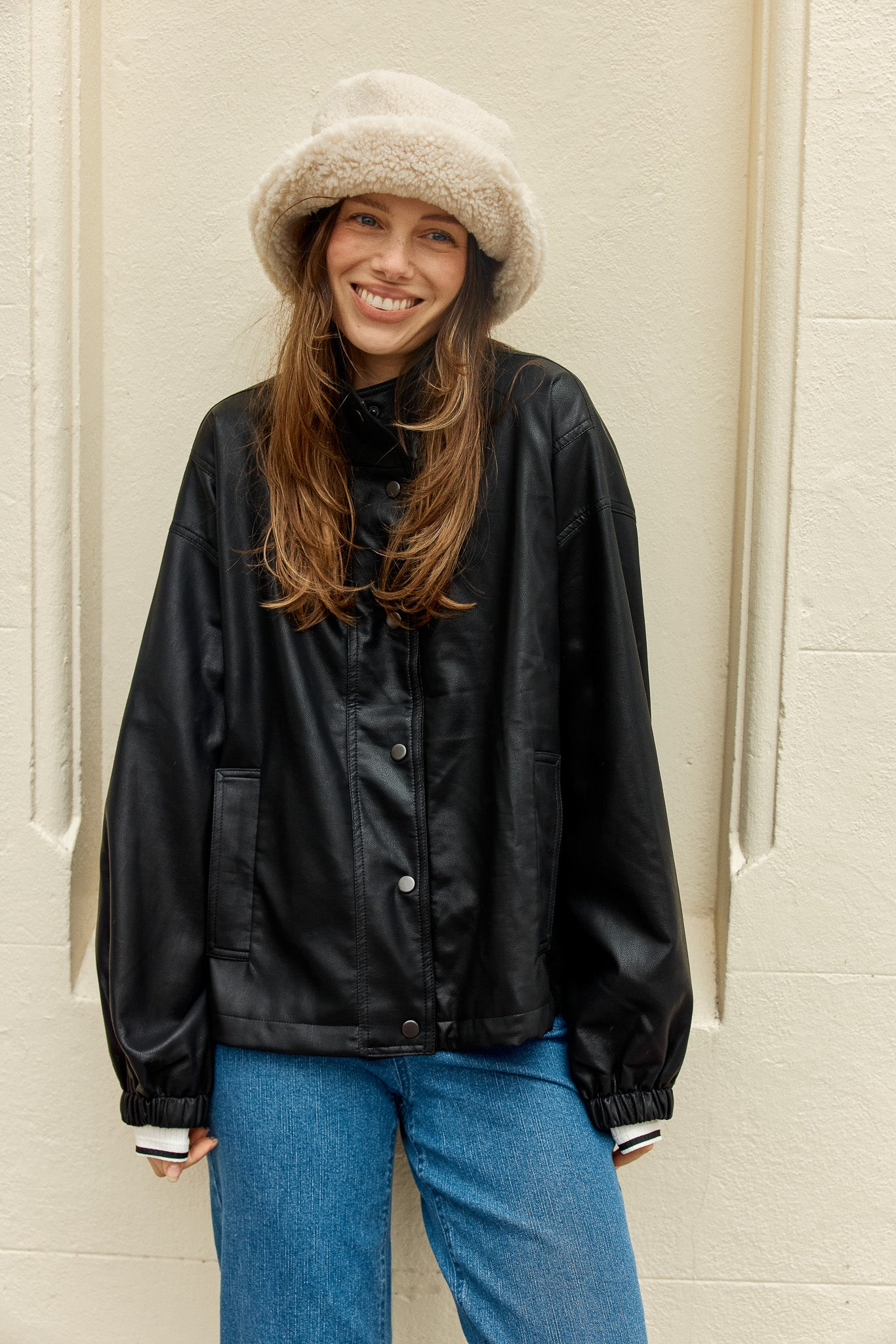 Image of a model wearing Outerwear. Product name - Polly PU Jacket Black PU in Black Pu colour by brand - Betty Basics