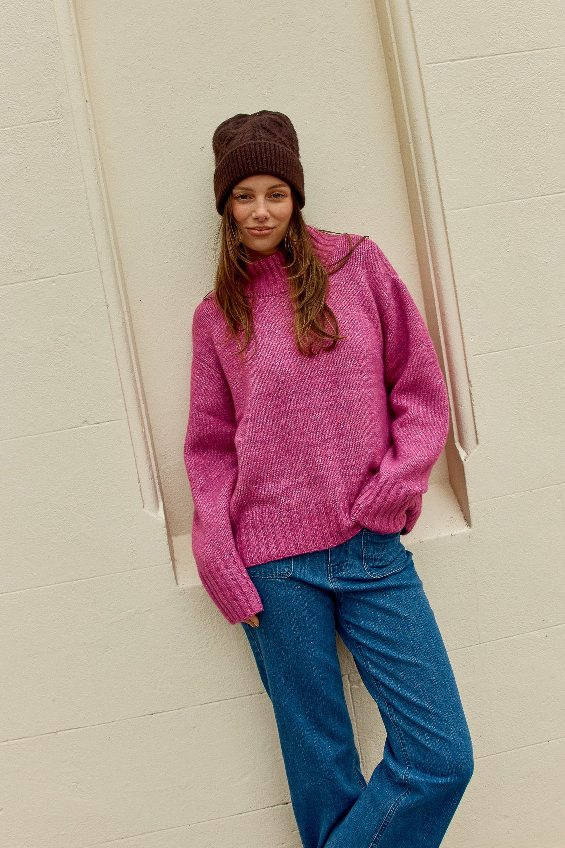 Image of a model wearing Outerwear. Product name - Lola Jumper Mulberry in Mulberry colour by brand - Betty Basics
