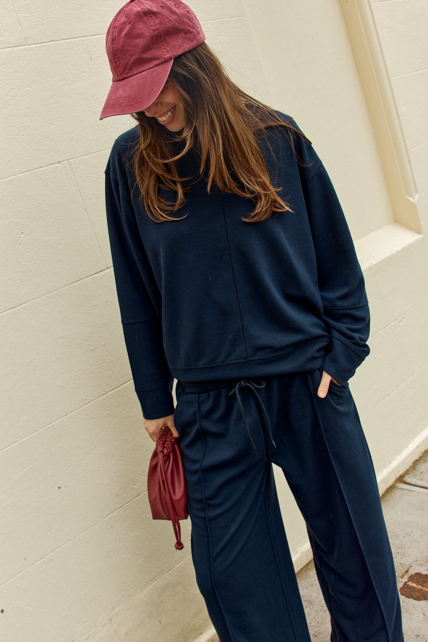 Image of a model wearing Outerwear. Product name - Elona Top Navy in Navy colour by brand - Betty Basics