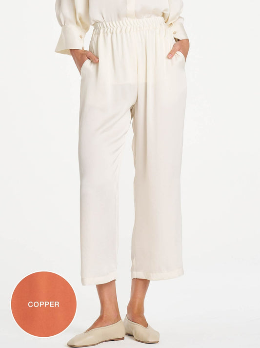 Image of a model wearing Pants. Product name - MELA PURDIE PACE PANT in Copper colour by brand - Mela Purdie