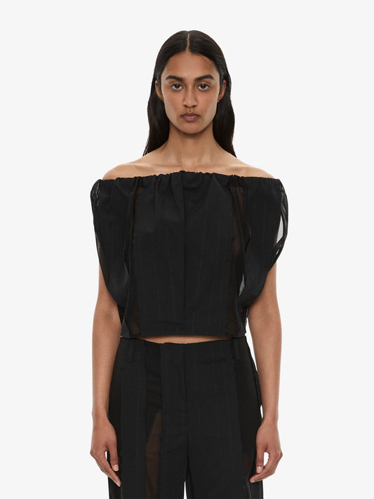Image of a model wearing Tops. Product name - Ignis Parachute Top in Black colour by brand - CHRISTOPHER ESBER