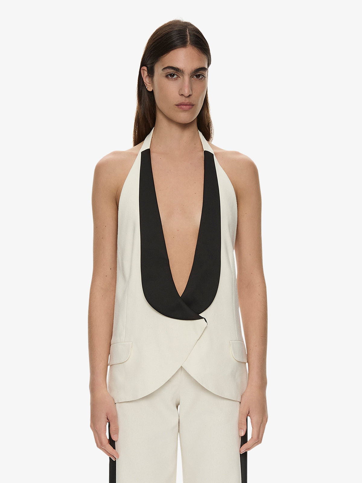 Image of a model wearing Tops. Product name - Tuxedo Contrast Silk Vest in Black colour by brand - Christopher Esber