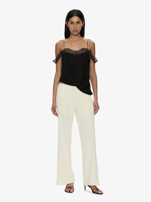 Image of a model wearing Pants. Product name - Bias Crepe Trouser in Cream colour by brand - CHRISTOPHER ESBER