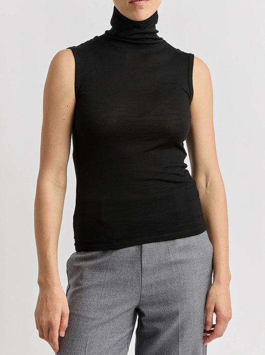 Image of a model wearing Tops. Product name - TOORALLIE SLEEVELESS ROLL NECK in Black colour by brand - Toorallie