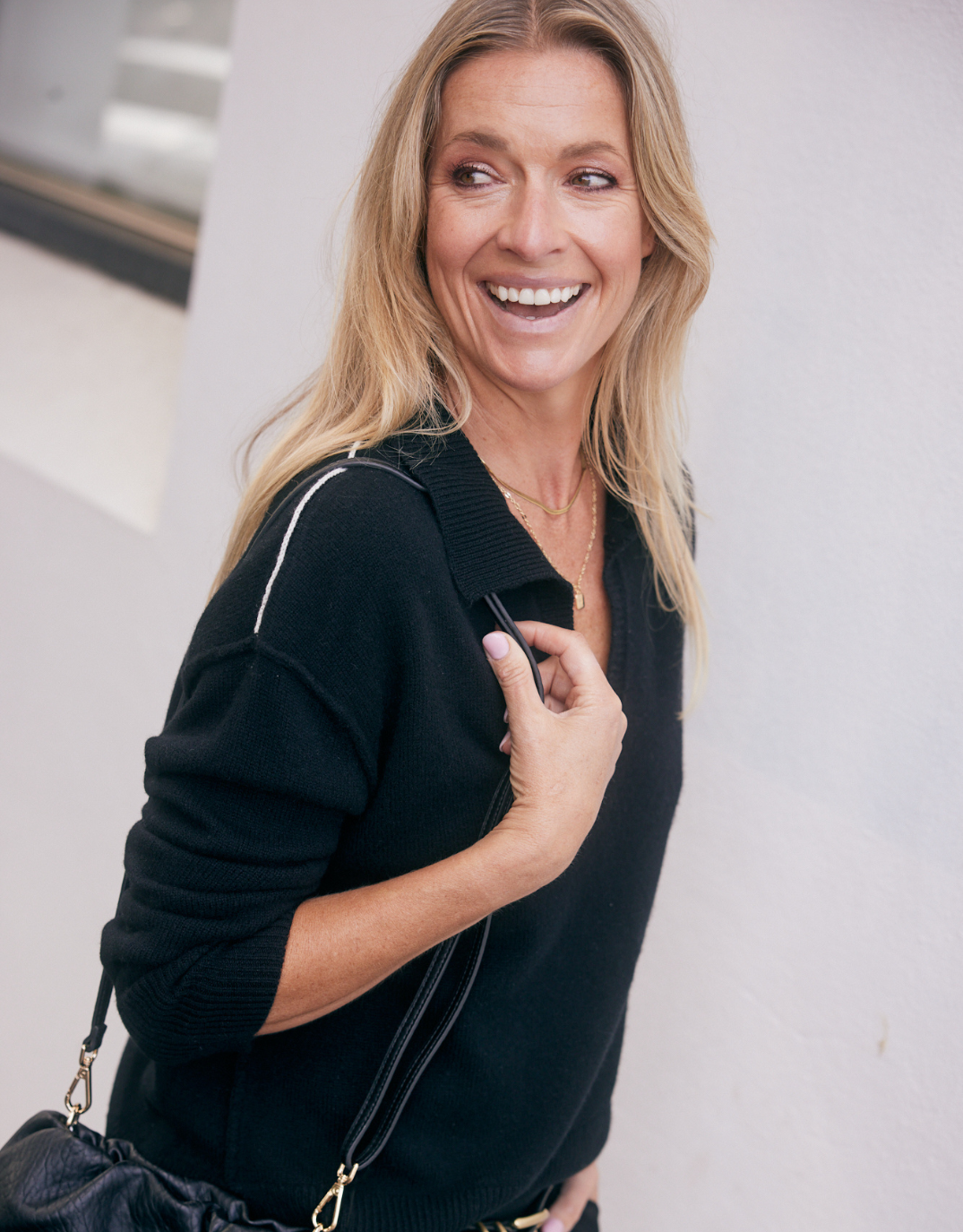 Image of a model wearing Outerwear. Product name - Provence Wool Cashmere Collared Knit Black in Black colour by brand - White & Co.