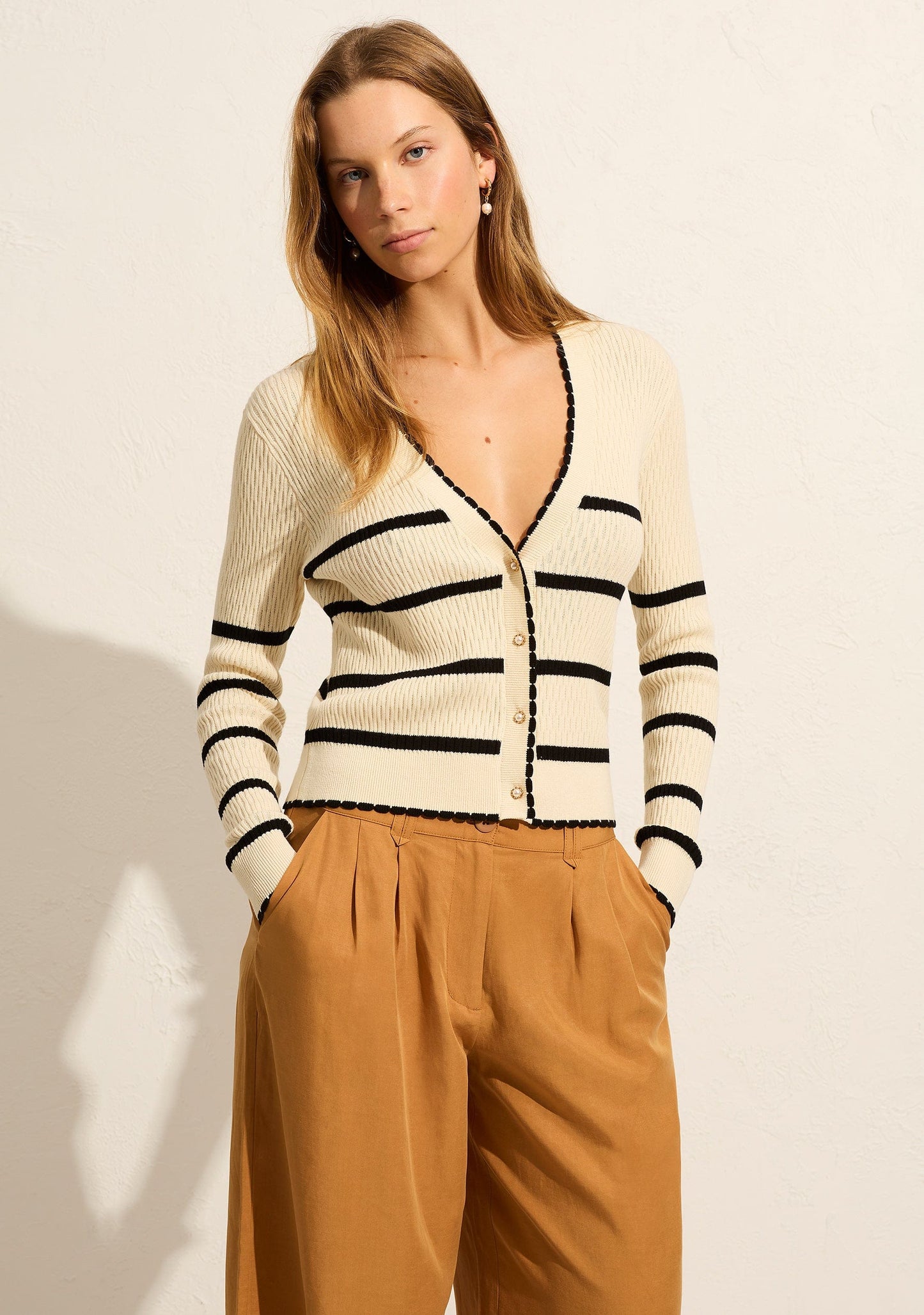 Image of a model wearing Outerwear. Productname: Auguste The Label Tommy Cardigan in Black colour by brand - Auguste The Label