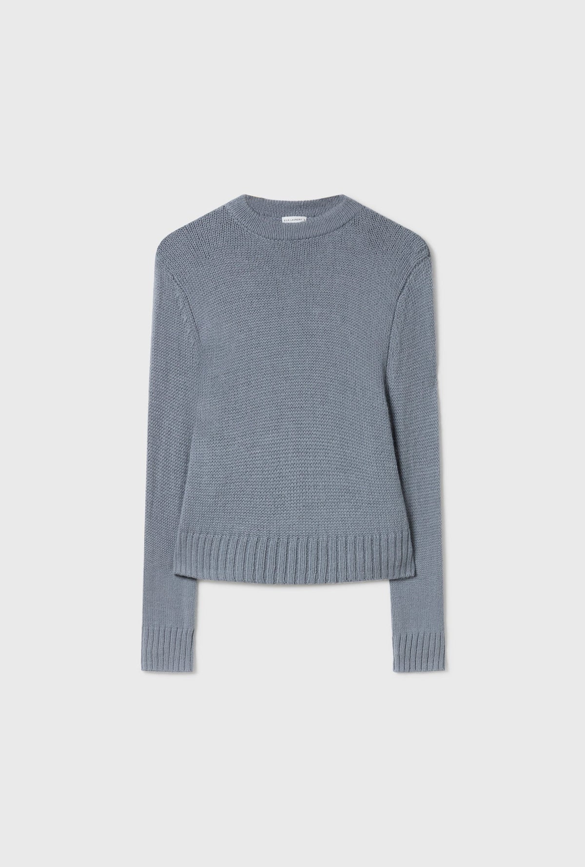 Image of a model wearing Outerwear. Product name - Alpaca Cropped Crewneck Storm in Storm colour by brand - Silk Laundry