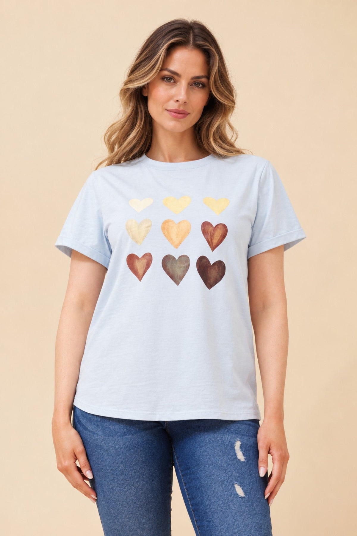 Image of a model wearing Tops. Product name - LURA HEART PRINT TSHIRT in Navy colour by brand - Caroline Morgan Australia