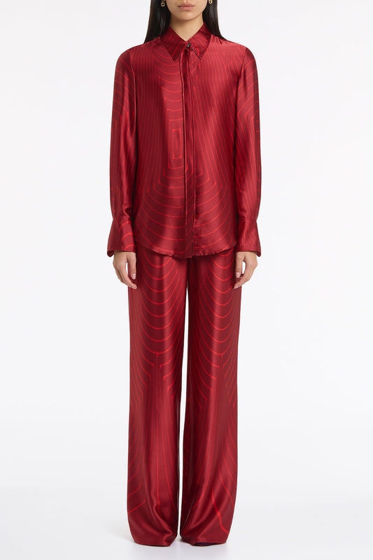 Image of a model wearing Tops. Product name - Undercurrent Silk Viscose Stretch Classic Blouse in Red colour by brand - Carla Zampatti