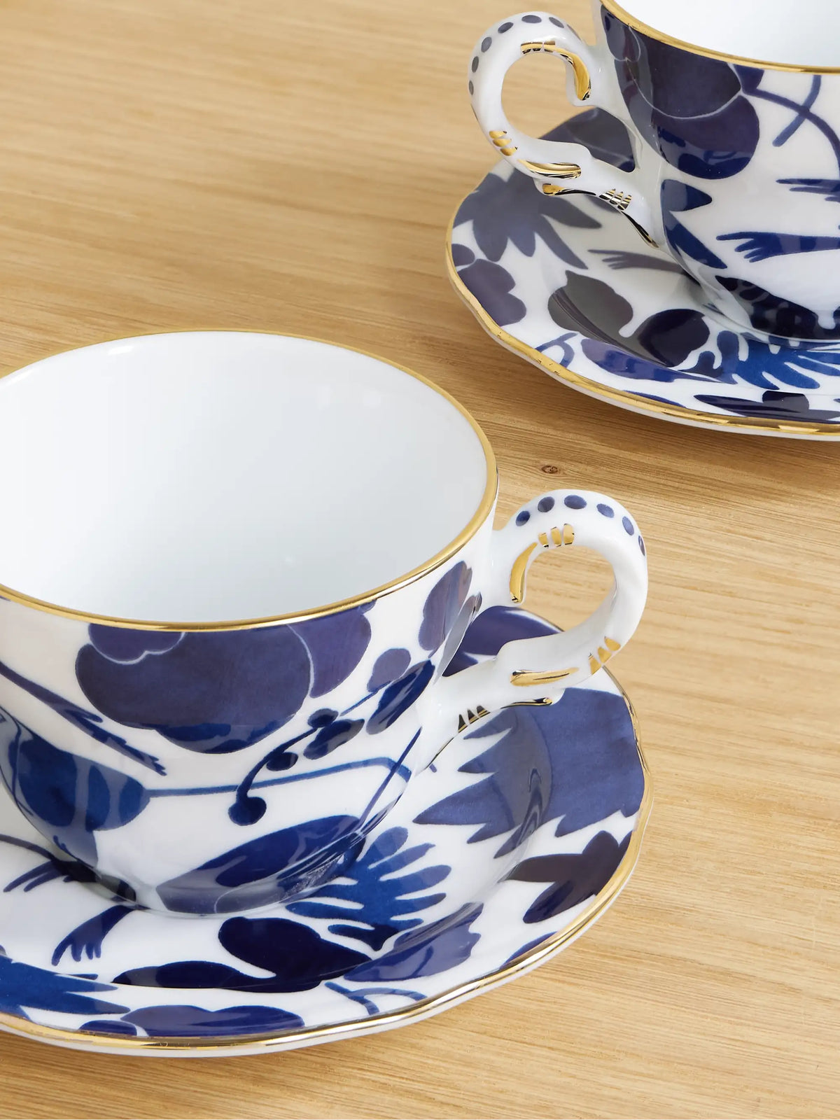 Set Of Two Gold-plated Porcelain Teacups And Saucers