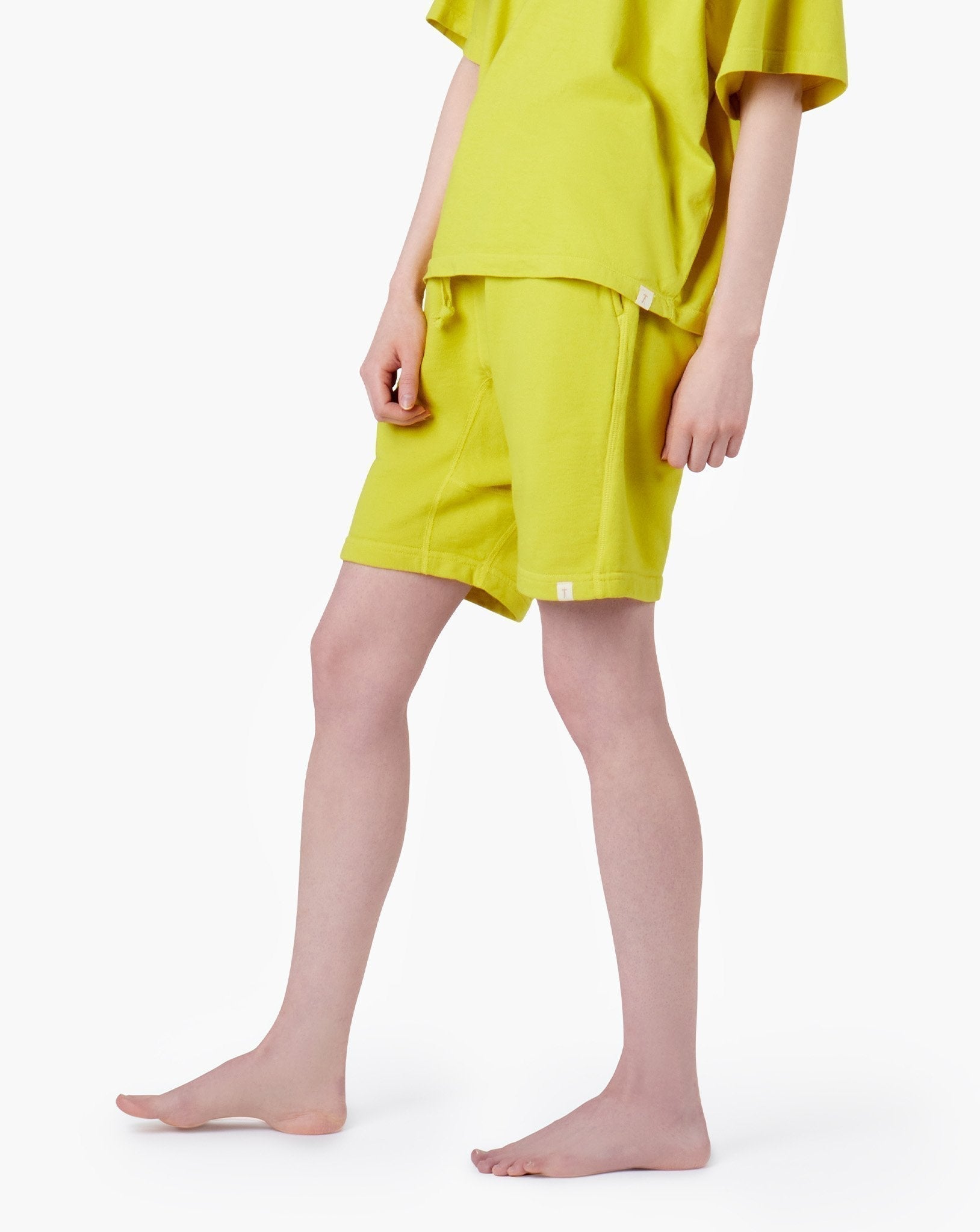 Image of a model wearing Shorts. Productname: Core Short Capri Lemon in Capri Lemon colour by brand - TKEES