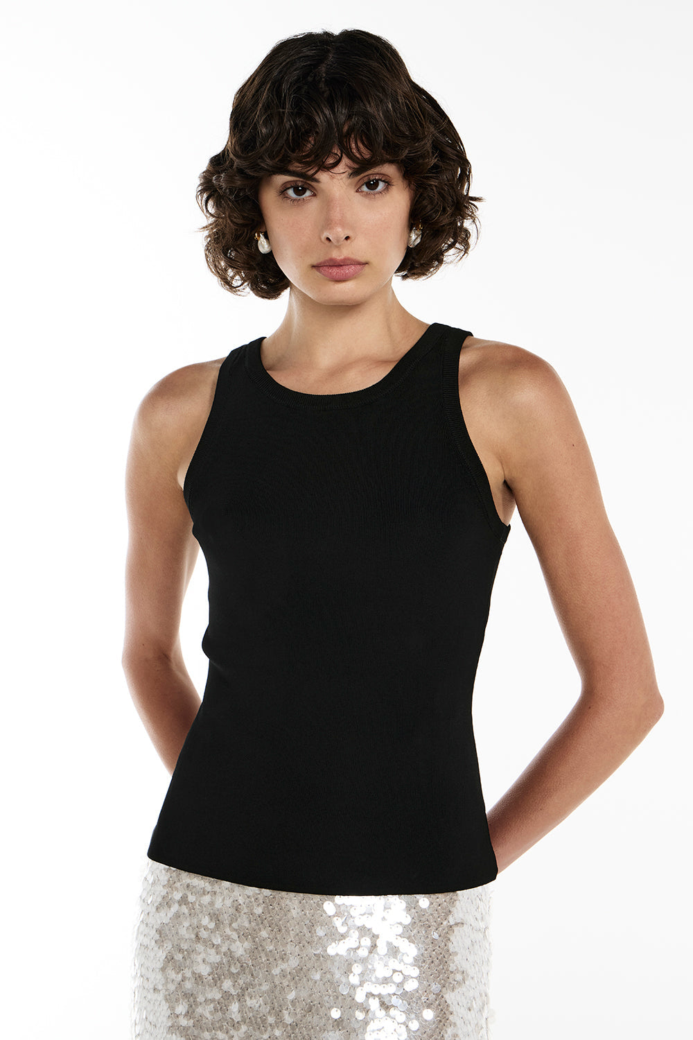 Image of a model wearing Tops. Productname: Catch Up Tank in BLACK colour by brand - Manning Cartell