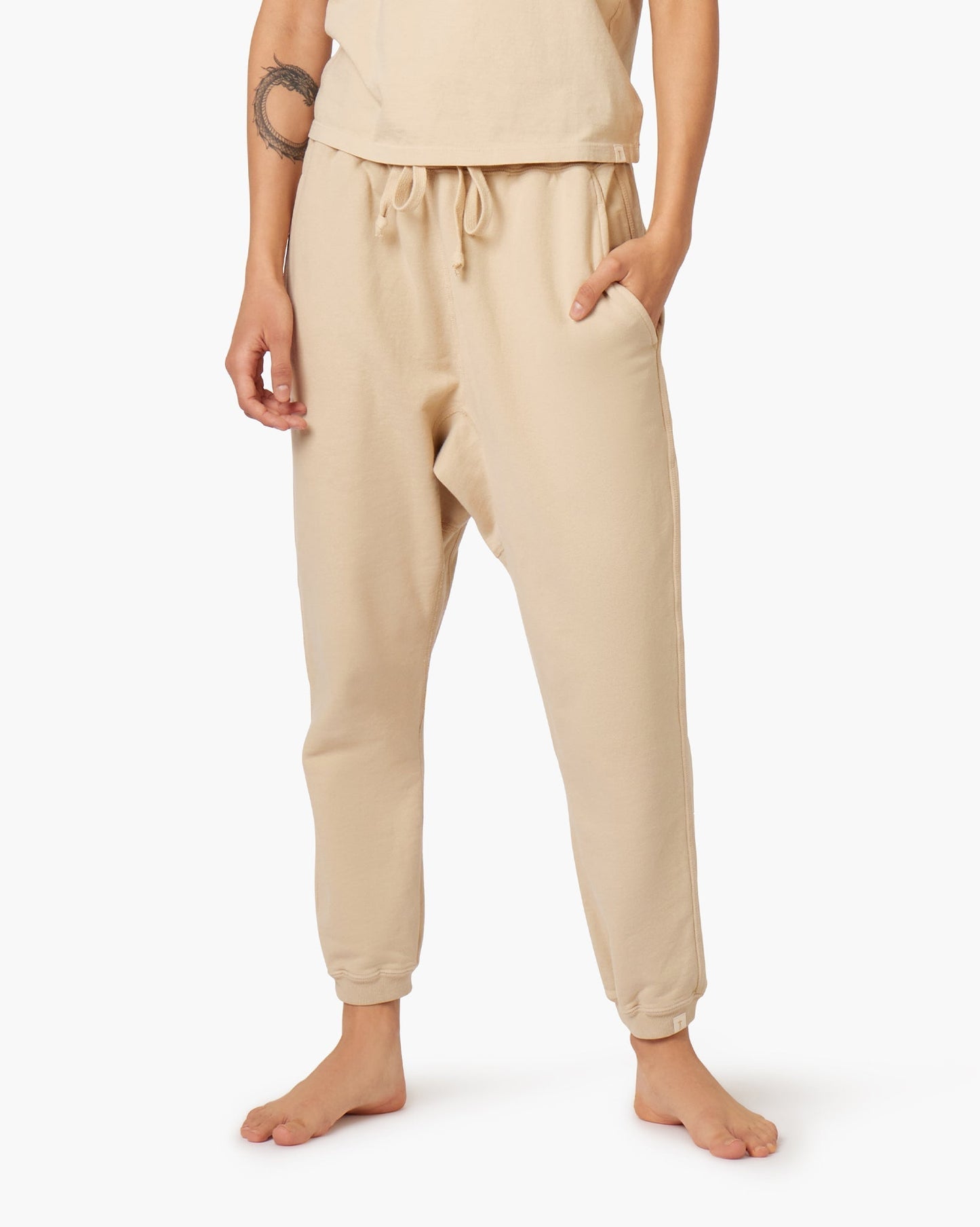 Image of a model wearing Pants. Productname: Core Jogger Latte in Latte colour by brand - TKEES