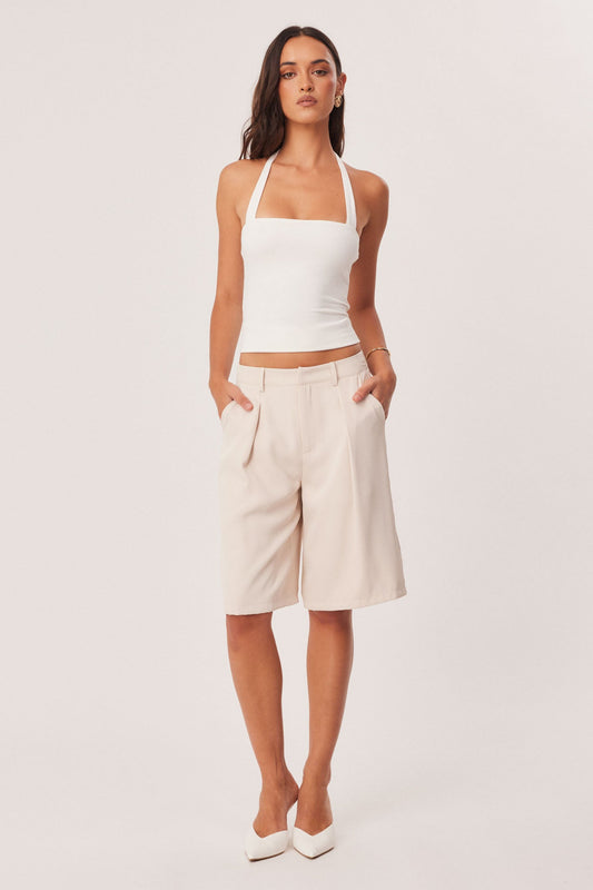 Image of a model wearing Shorts. Productname: SNDYS REECE BERMUDA SHORTS in Stone colour by brand - SNDYS