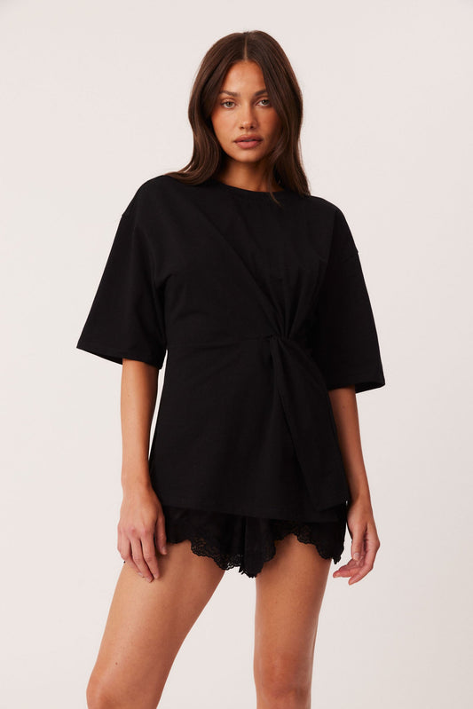 Image of a model wearing Tops. Productname: SNDYS ZAIRA KNOT T-SHIRT in Black colour by brand - SNDYS