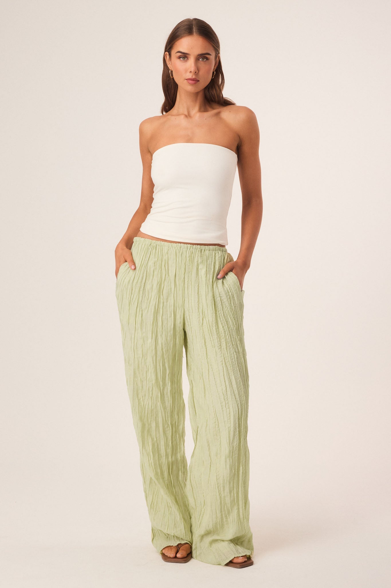 Image of a model wearing Pants. Productname: SNDYS BRANDI CRINKLE PANTS in Matcha colour by brand - SNDYS