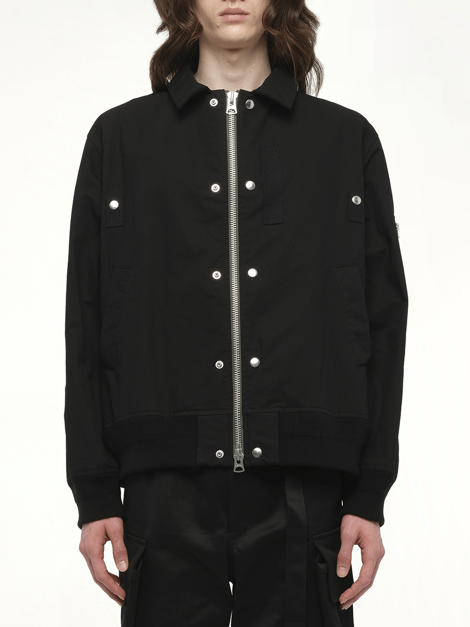 Image of a model wearing Outerwear. Productname: SACAI Rip Stop Blouson in Black colour by brand - SACAI