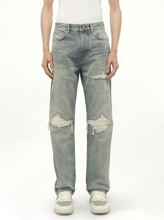 Image of a model wearing Denim. Productname: AMIRI Suede Straight MX1 Jeans in Blue colour by brand - AMIRI