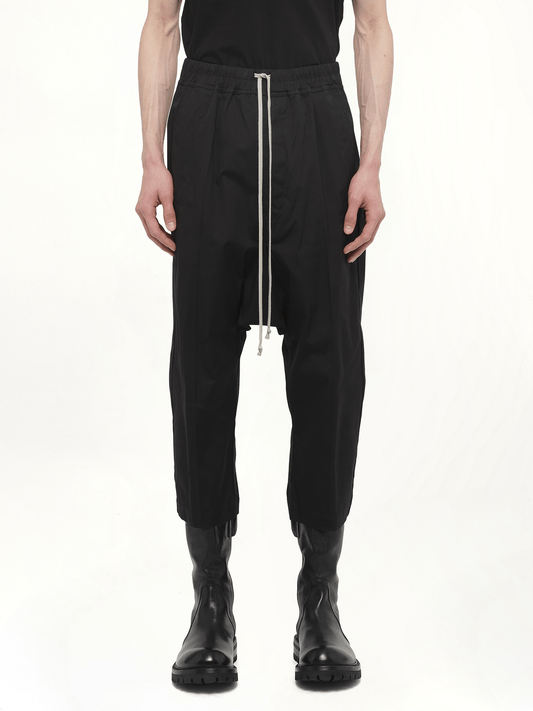 Image of a model wearing Pants. Productname: RICK OWENS Drawstring Cropped Pants in Black colour by brand - RICK OWENS