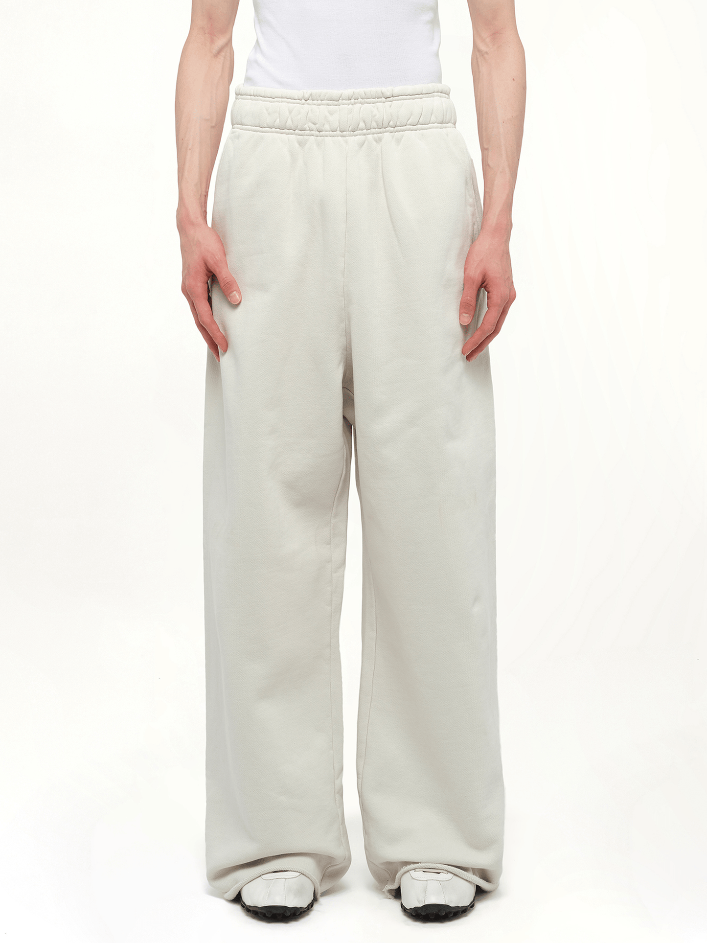 Image of a model wearing Pants. Product name - Full Sweatpants in White colour by brand - ENTIRE STUDIOS