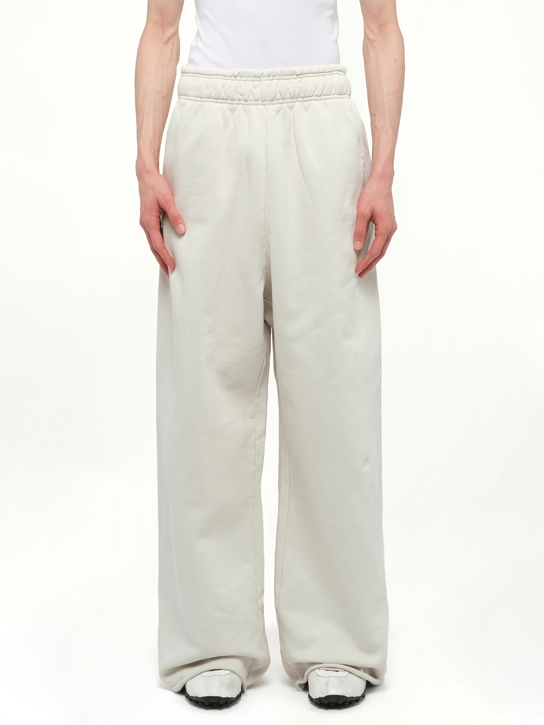 Image of a model wearing Pants. Product name - Full Sweatpants in White colour by brand - ENTIRE STUDIOS