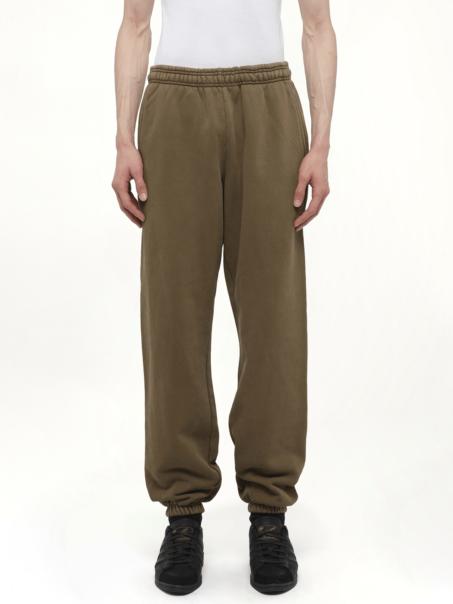 Image of a model wearing Pants. Productname: Heavy Sweatpants in Brown colour by brand - ENTIRE STUDIOS