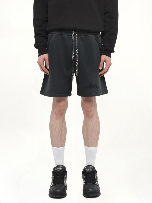Image of a model wearing Shorts. Productname: AMIRI Bleach Bandana Shorts in BLACK colour by brand - AMIRI