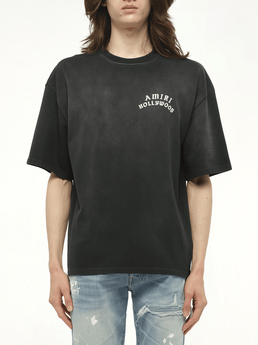 Image of a model wearing Tops. Productname: AMIRI Amiri Hollywood T-Shirt in BLACK colour by brand - AMIRI