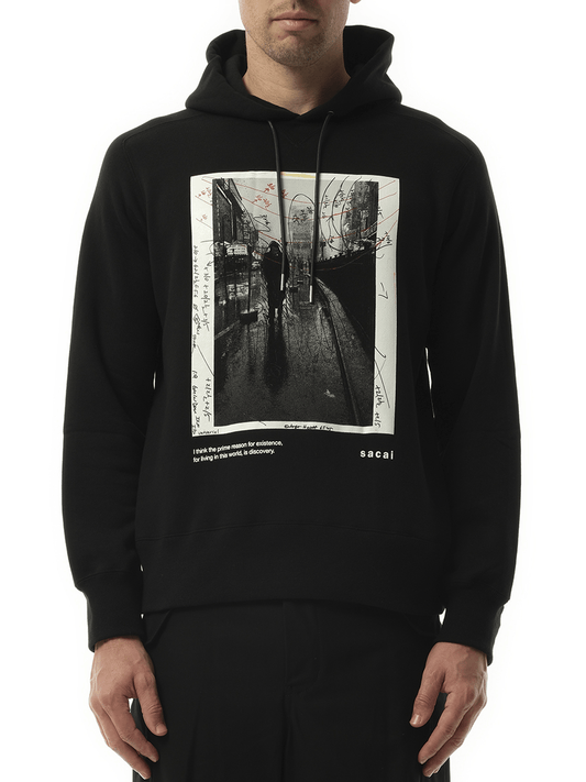 Image of a model wearing Outerwear. Productname: SACAI James Dean Photo Hoodie in BLACK colour by brand - SACAI
